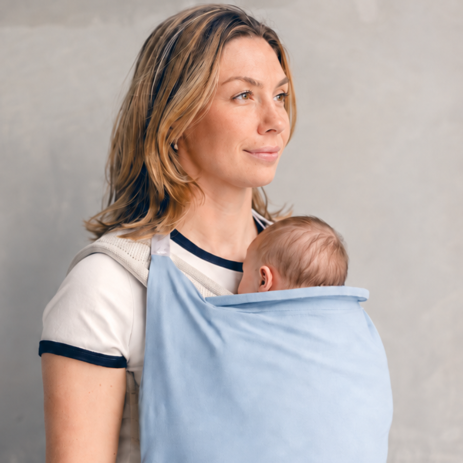 Lightweight baby carrier sun cover clipped securely over structured baby carrier