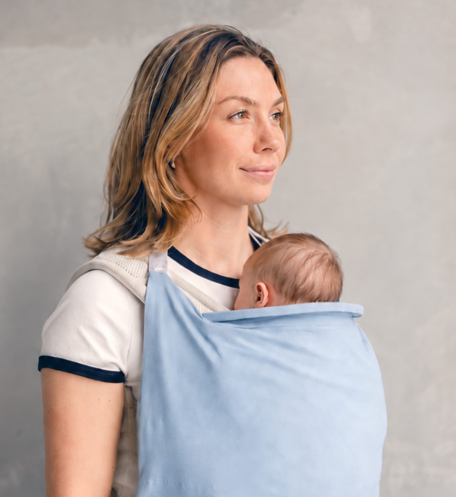 Lightweight baby carrier sun cover clipped securely over structured baby carrier