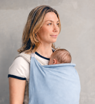 Lightweight baby carrier sun cover clipped securely over structured baby carrier