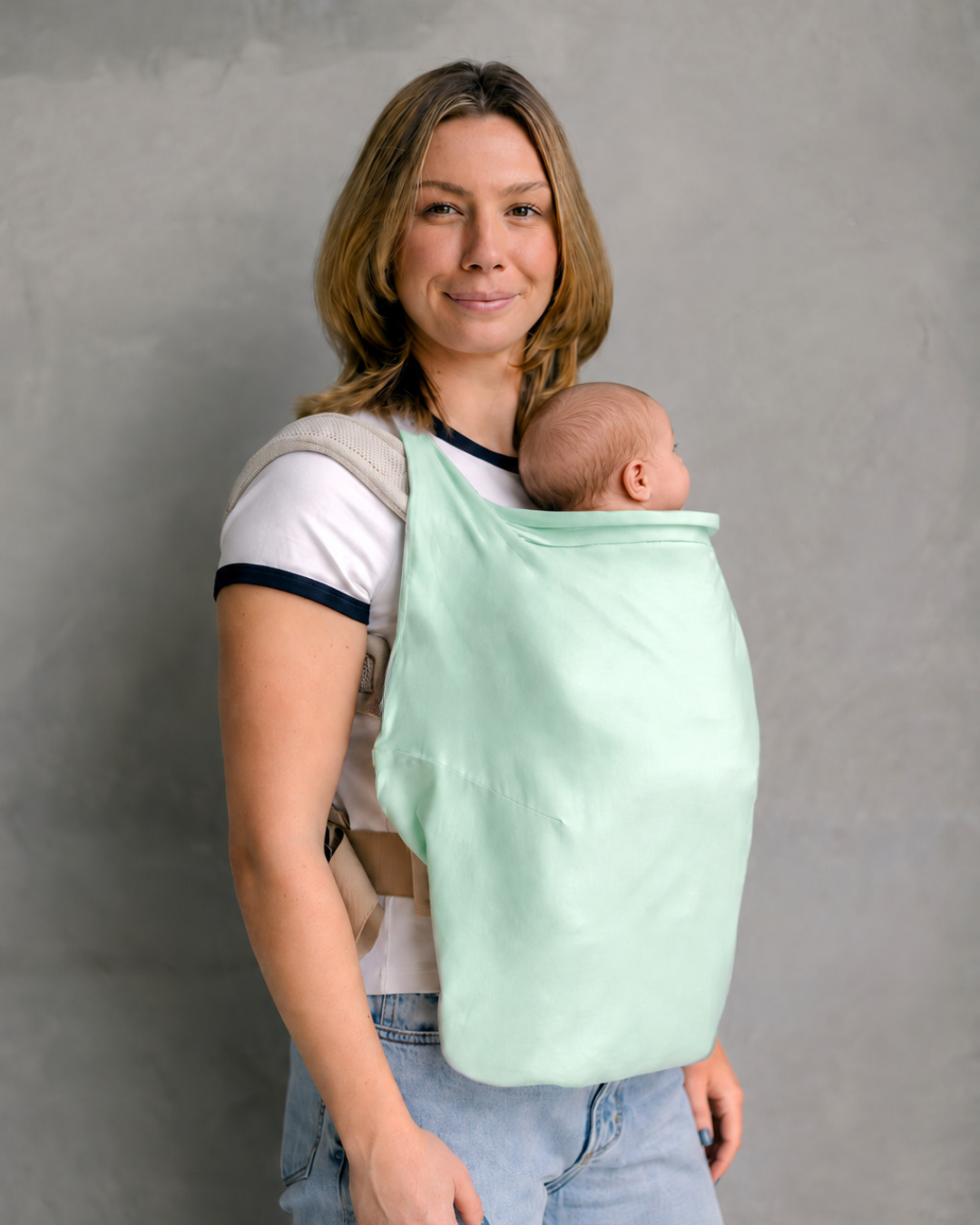 Mum babywearing with Gumnut Green Shady Baby UPF50+ carrier sun cover